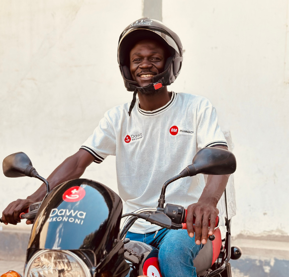 A Dawa Mkononi delivery rider on a branded motorbike